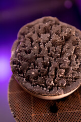 Used, destroyed, with deformation. Filter of harmful emissions, catalyst from the vehicle. detail close up view. Material containing precious metals. Muffler of the exhaust system. Vertical photo