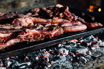 Barbeque, bbq meat cooking on grill. Traditional Asado of Argentina, Paraguay y Uruguay.
