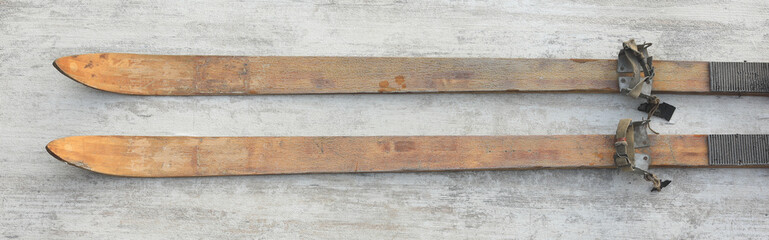 vintage wooden skis on white wooden background