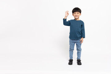 Happy Asian little boy showing ok sign isolated on white background, Agree concept, Looking at...