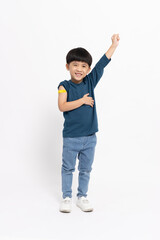Happy Asian little boy showing arm with plaster of Hand-foot-mouth disease vaccine isolated on white background, Adhesive bandage on arm after injection of vaccine concept, Five years old