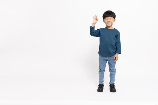 Happy Asian Little Boy Showing Ok Sign Isolated On White Background, Agree Concept, Looking At Camera And Full Body Composition