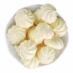 French meringue cookies, yellow twisted crispy meringue in bowl isolated on white.