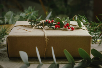 Christmas gift box wrapped in brown paper. Eco friendly Christmas present packaging. 