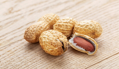 Peanut. A pod of peanut beans. Close-up. On a wooden table.