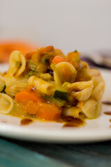 Pasta with pumpkin, leek, carrots and zucchini garnished with Teriyaki sauce
