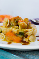 Pasta with pumpkin, leek, carrots and zucchini garnished with Teriyaki sauce