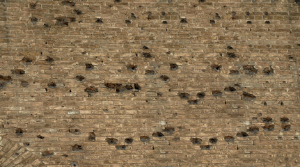Old brick wall with traces of bullets