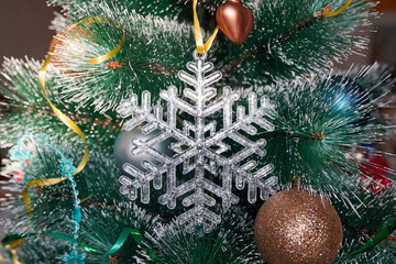 Christmas crystal snowflake on Christmas tree with blue Ribbon