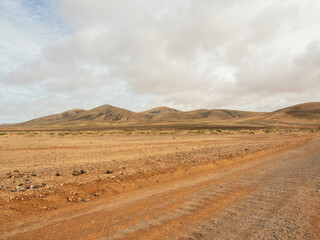Fototapeta na wymiar Mountains next to track in Fuerteventura