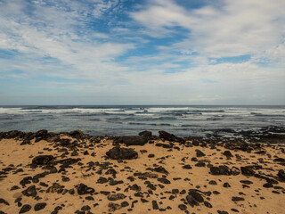 Volcanic rocks on the sand of El Hierro beach in Fuerteventura