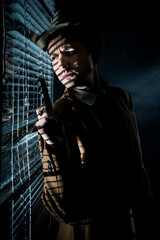 A private detective by the window with blinds, looking at the street,dramatic cinema scene.