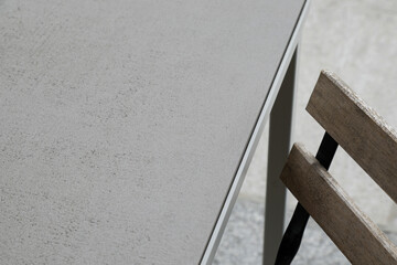 Detail and close up of a garden chair and stone table on a terrace,
no person