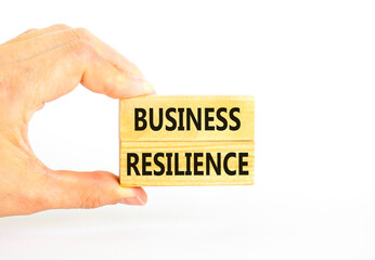 Naklejka na ściany i meble Business resilience symbol. Concept word Business resilience typed on wooden blocks. Beautiful white table white background. Businessman hand. Business and business resilience concept. Copy space.