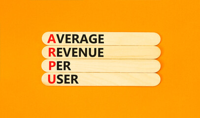 ARPU average revenue per user symbol. Concept words ARPU average revenue per user on wooden stick on beautiful orange background. Business ARPU average revenue per user concept. Copy space.