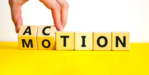 Action or motion symbol. Concept word Motion and Action on wooden cubes. Businessman hand. Beautiful yellow table white background. Business and action or motion concept. Copy space.