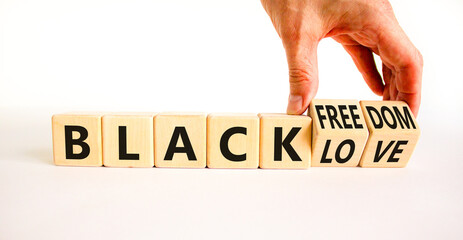 Black freedom and love symbol. Concept words Black freedom Black love on wooden cubes. Businessman hand. Beautiful white table white background. Black freedom and love concept. Copy space.