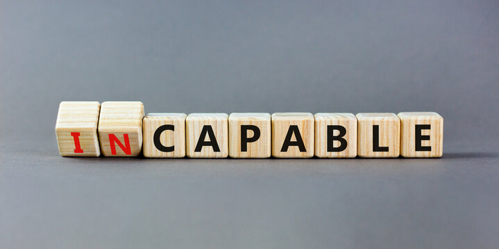 Capable or incapable symbol. Concept words Capable or Incapable on wooden cubes. Beautiful grey table grey background. Business capable or incapable concept. Copy space.