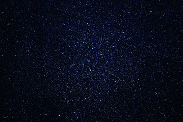 Deep space with myriads of stars of different luminosity. Background with outer space dotted with many stars.