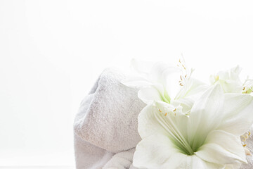 Close-up, lily flowers and a towel on a white background isolated.