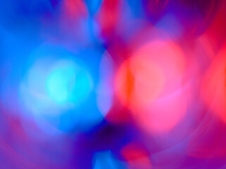 Background with blurred red and blue colors. A kaleidoscope with two bright colors. Color abstraction in the form of pink and blue spots.