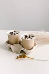 Two small cakes in paper cups. Natural. Cake to go. Space for text