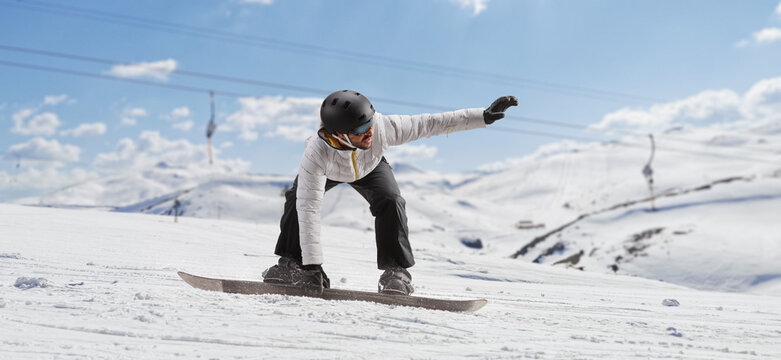 Man Gliding With A Snowboard On A Mountain