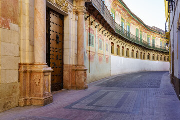 Narrow alley with palaces and aristocratic houses of the picturesque town of Ecija in Seville.
