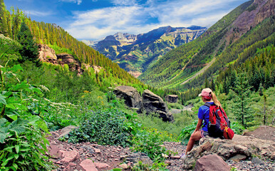 Hiker resting at the top of the Bear Creek Trail, Telluride, Colorado