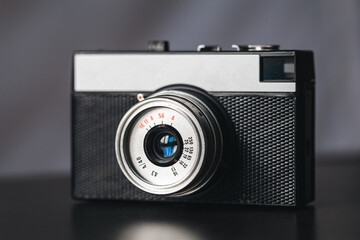 Close-up, film retro camera on a blurred background.