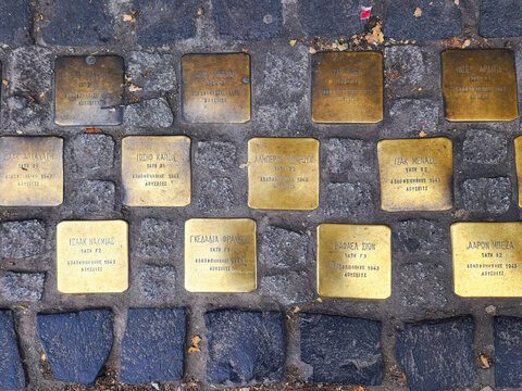 Thessaloniki, Greece top-down street view of Jewish memorial stolpersteine outside a high school with the names of students murdered in Auschwitz in 1943.