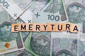 Inscription Emerytura next to polish money. Concept showing retirement in Poland