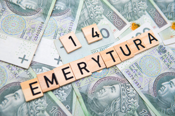 inscription 14 Emerytura which means 14 pension next to polish money. Concept showing program of social policy in Poland