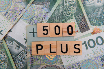 inscription 500 plus next to polish money. 500 plus is a state program in the field of social policy