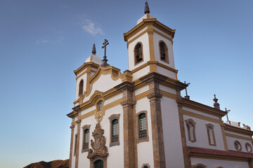 Fototapeta na wymiar The famous baroque-rococó styled Nossa Senhora do Carmo church at the Minas Gerais square, in the historical town of Mariana, in the state of Minas Gerais on a bright sunny day light afternoon.