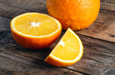 Close-up, slices of orange on a wooden background.