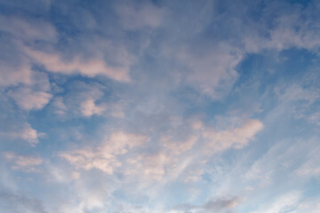 Summer evening sky in the picturesque clouds, lit by the rays of the setting sun.