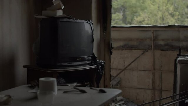 Kharkiv, eastern Ukraine 25.05.2022. Abandoned ruins of an ordinary Ukrainian flat. TV melted after fire caused by russian missiles and mass shootings in residential area of an occupied city