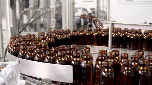 Pharmaceutical production line. Industrial Line Of Food, Medical Industry For Filling Liquids Into Bottles. Supply conveyor device