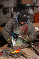 Fototapeta premium Welding process in the industrial workshop by worker