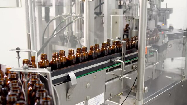 Pharmaceutical production line. Industrial Line Of Food, Medical Industry For Filling Liquids Into Bottles. Supply conveyor device