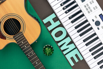 Musical keys, guitar and decorative word home on a colored background.