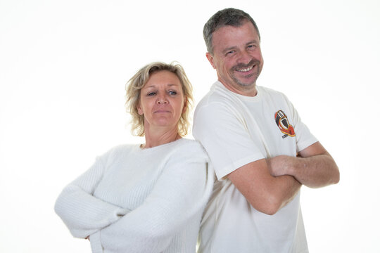 Middle age couple back to back arms crossed woman man in white background