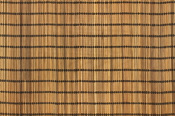 Brown toned bamboo sticks bound with black threads background