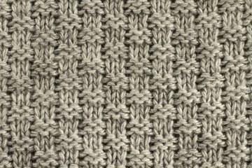 Light gray with black melange knitted wool fabric texture. Macro. Closeup.