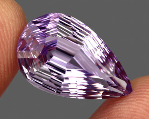 Natural stone purple amethyst on a gray background