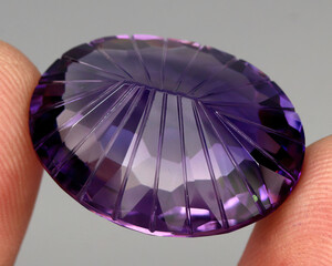 Natural stone purple amethyst on a gray background