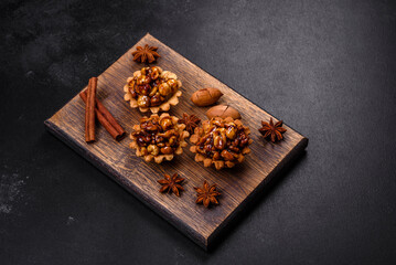 Sweet tasty tart with nuts and honey on a dark concrete background