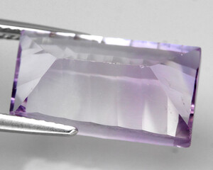 Natural stone purple amethyst on a gray background