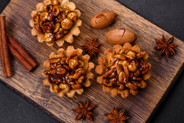 Sweet tasty tart with nuts and honey on a dark concrete background
